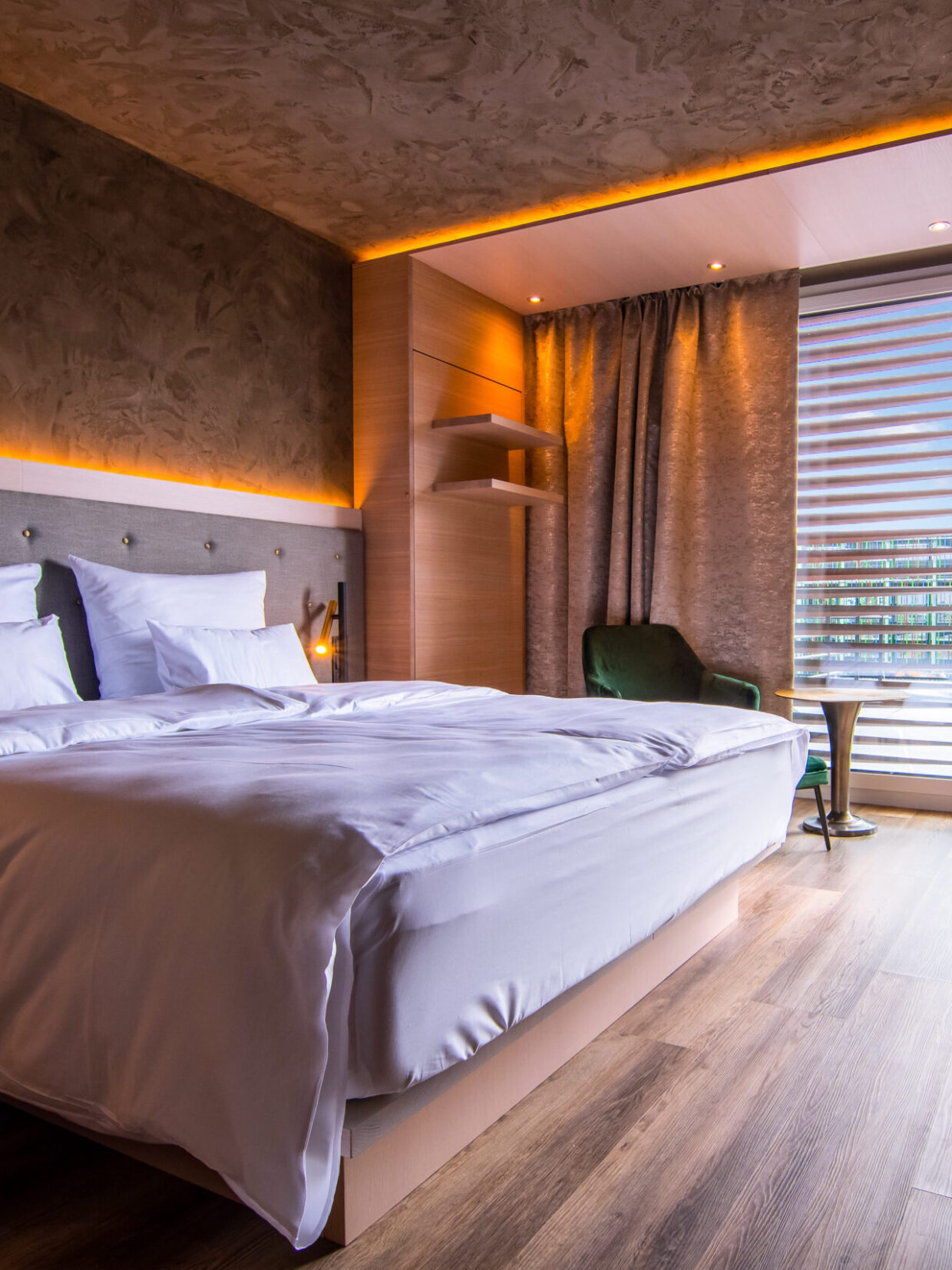 Modern hotel rooms with double beds and balconies.