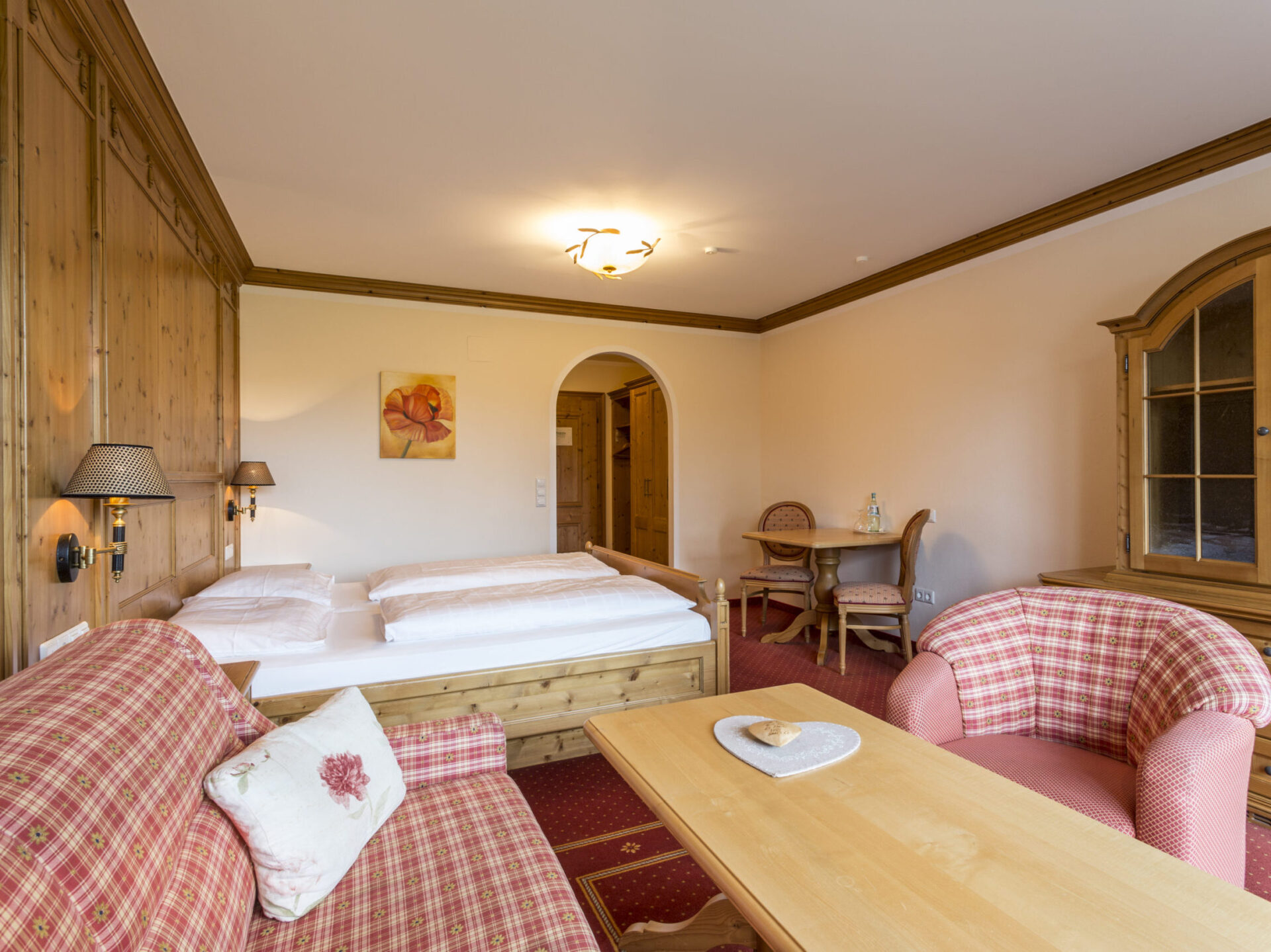 Spacious Comfort room with balcony in country house style with double bed, sitting area and desk