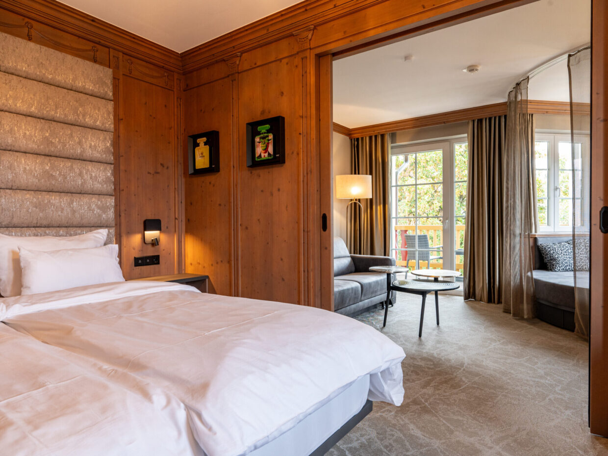 Spacious sleeping area with soft bed and direct connection to a bright living area.