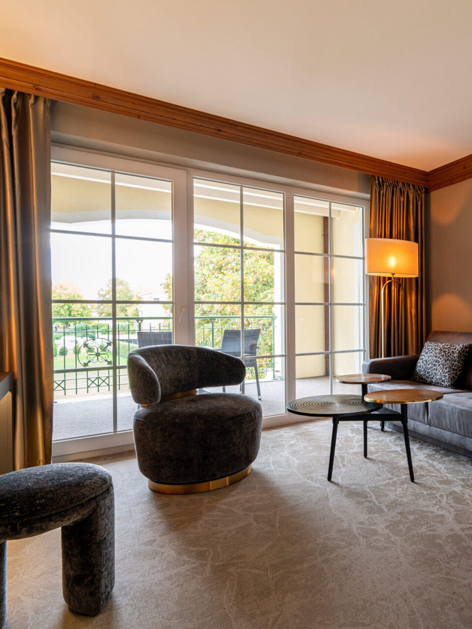 Modern superior room with balcony and cozy sitting area in the Meiser SPA Resort.