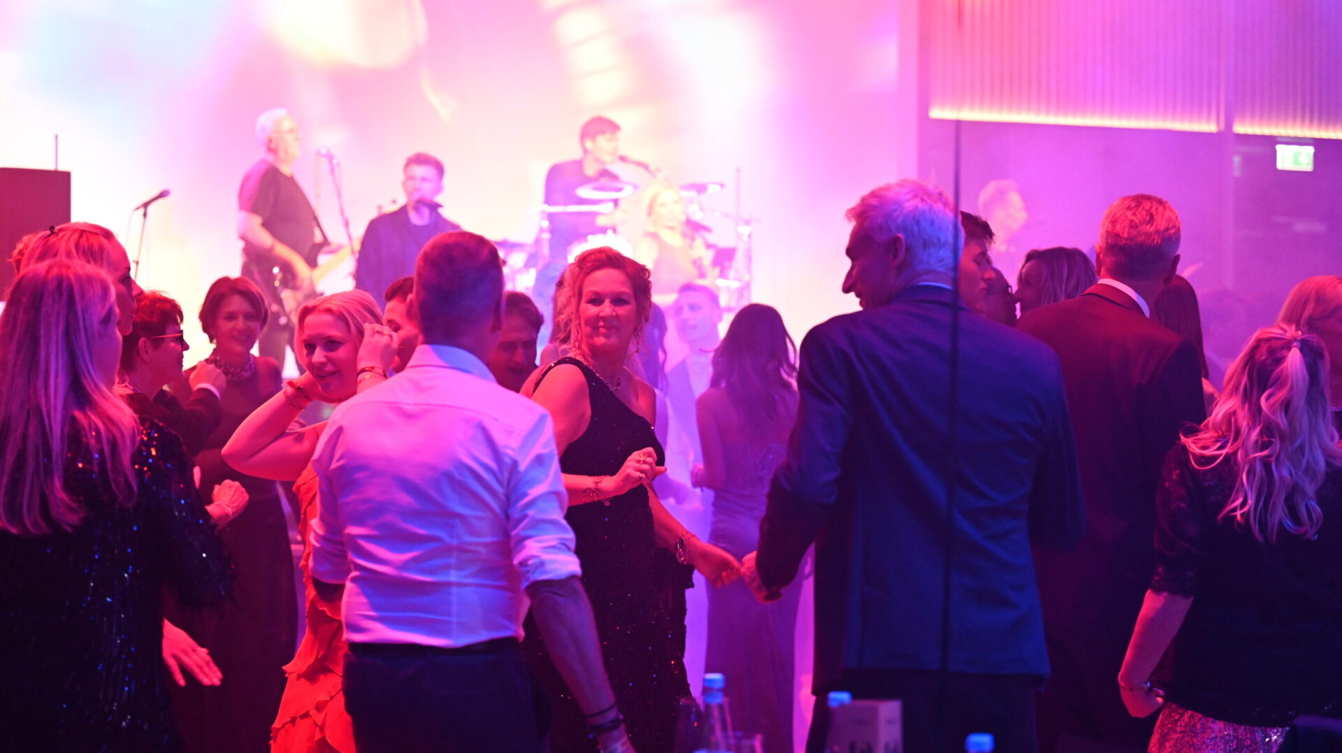 People dance at a festive event in the Meiser Congress Plaza.