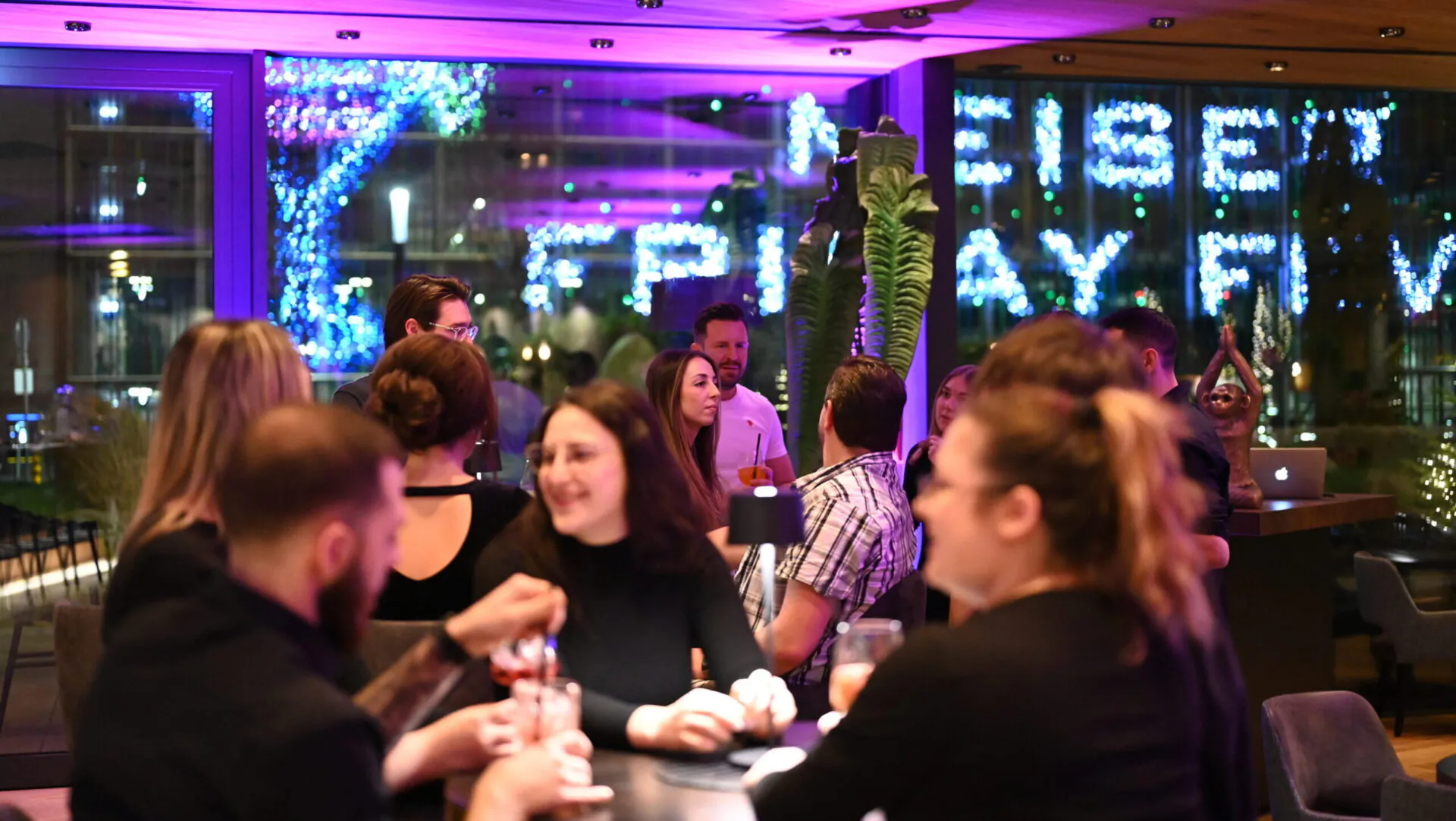 Gesellige Menschen in einer festlichen Bar bei Nacht.